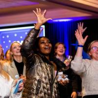 Grads raise their hands to catch giveaways at Toast